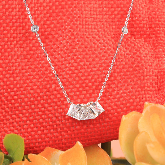 Silver prong set thee square diamond bow pendant with chain