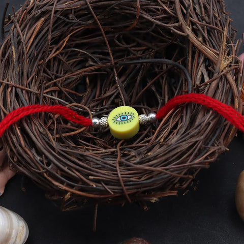 Yellow Round Shape Evil Eye With Silver Beads Rakhi for Kids