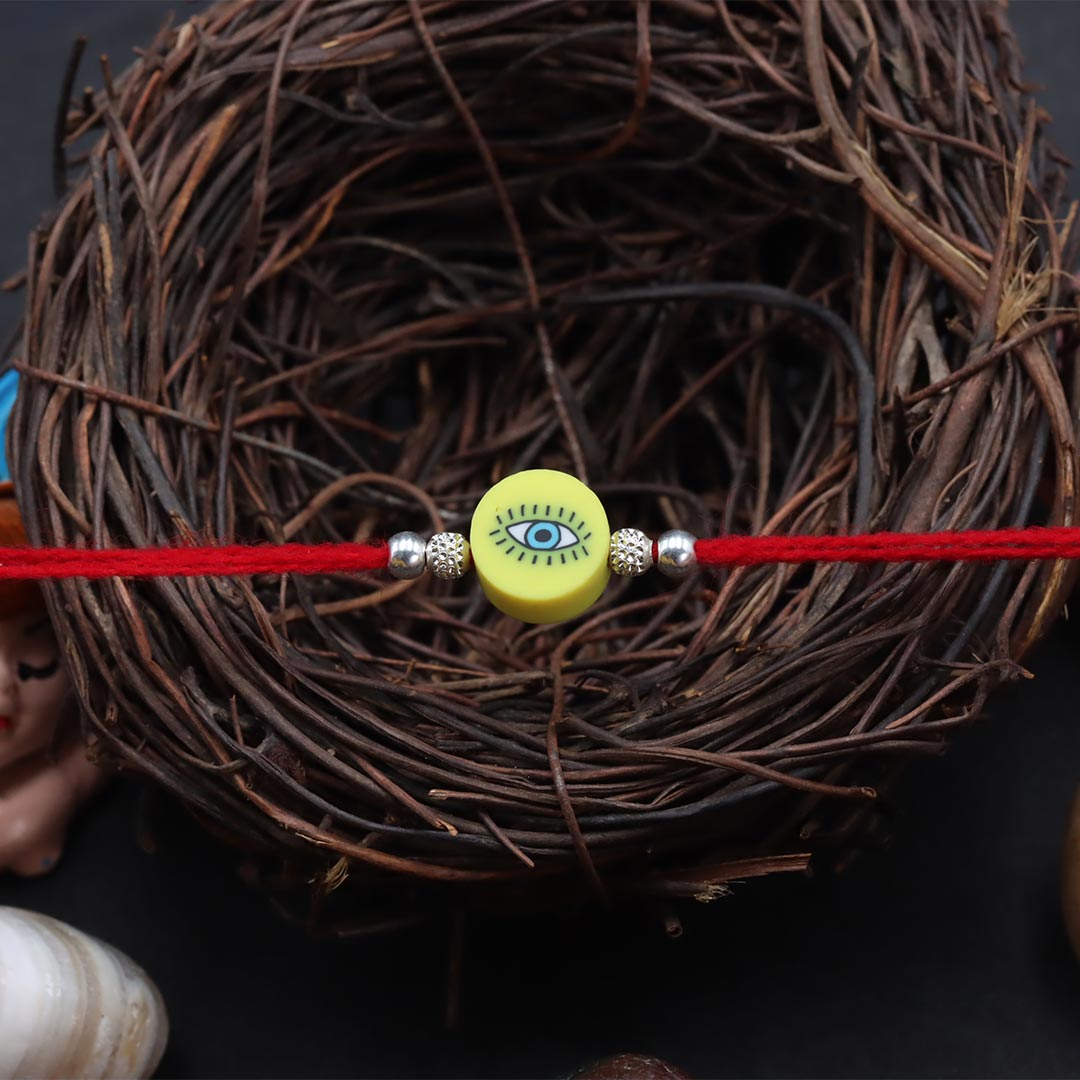 Yellow Round Shape Evil Eye With Silver Beads Rakhi for Kids